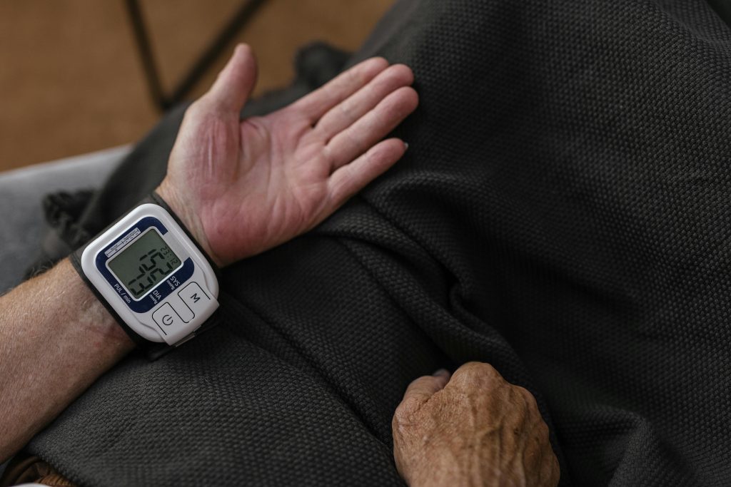 Person taking blood pressure on their arm