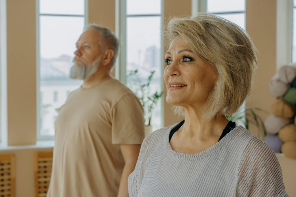 Older man and woman standing next to each other