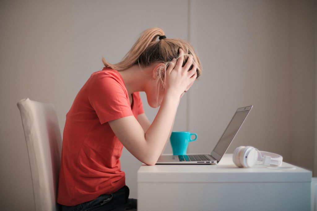 Woman-sitting-at-a-computer-stressed-out